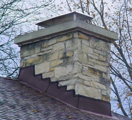 Stone chimney  with Repaired Flashing, crown and new, stainless steel Cap