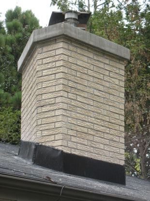 Brick chimney with Repaired Flashing and crown