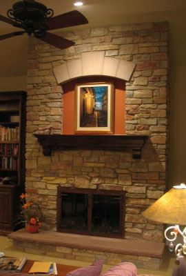 Finished firebox repair with stone surround and wood mantel
