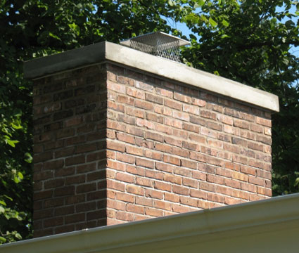 Brick Chimney with completed tuckpointing repairs, new Crown Coat, and new stainless steel chimney cap