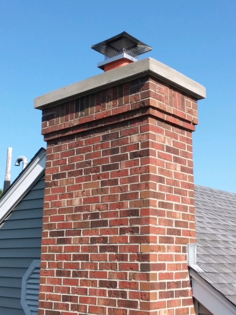 Repaired brick chimney and crown with new stainless steel chimney cap