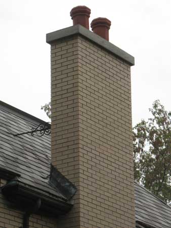 Finished chimney masonry repairs with fresh new crown coat and two new clay pot chimney caps